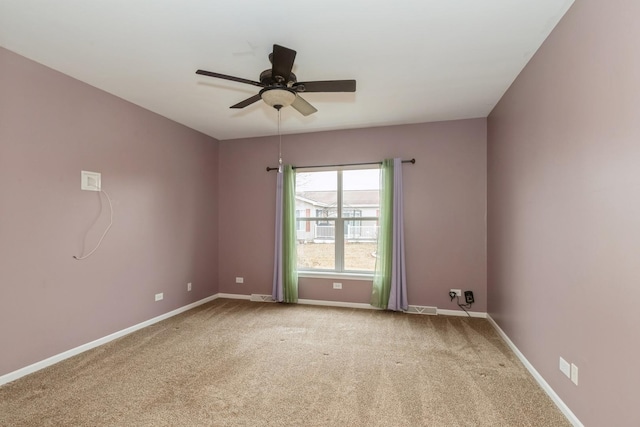 unfurnished room featuring ceiling fan and carpet