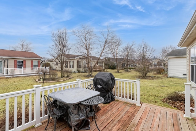 wooden terrace with a grill and a yard