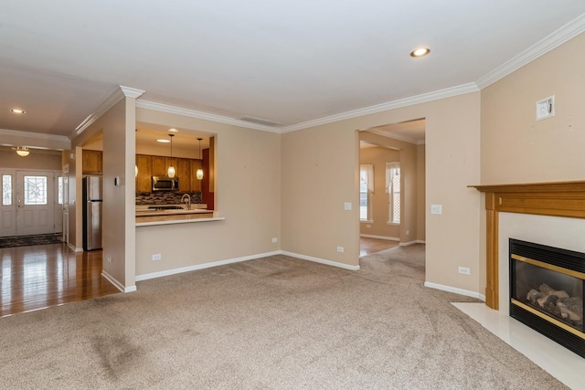 unfurnished living room with crown molding and carpet flooring