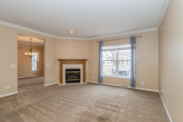 unfurnished living room featuring crown molding, a healthy amount of sunlight, a chandelier, and a tile fireplace