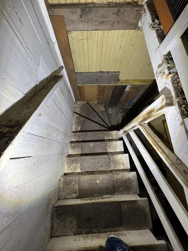 stairway with wood walls