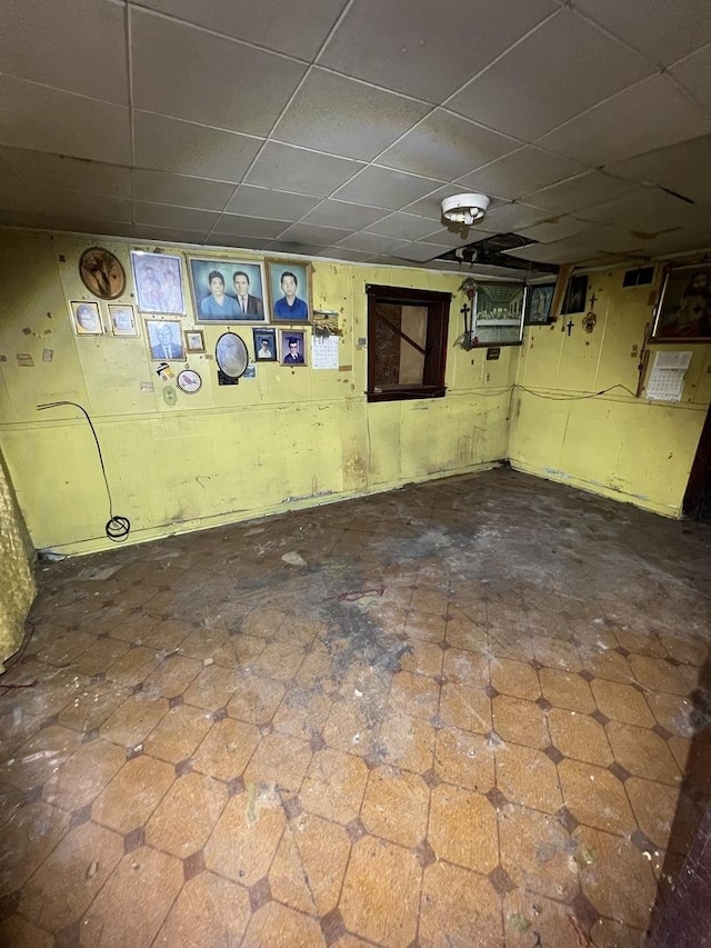 basement with a paneled ceiling