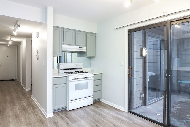 kitchen with white range with gas cooktop and light hardwood / wood-style floors