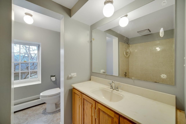 bathroom featuring vanity, toilet, a tile shower, and a baseboard radiator