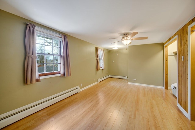 spare room featuring ceiling fan, light hardwood / wood-style flooring, and a baseboard radiator