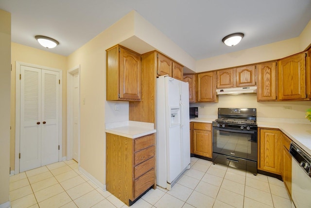 kitchen featuring light tile patterned flooring and white appliances