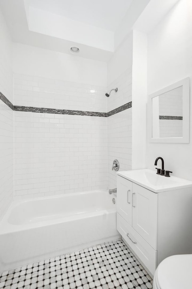 full bathroom with tile patterned floors, toilet,  shower combination, and vanity