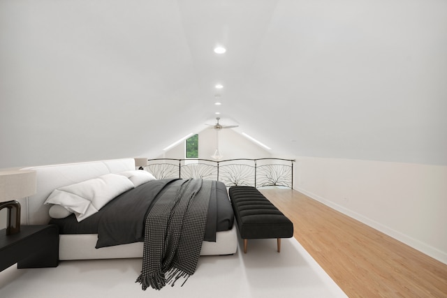 bedroom with hardwood / wood-style floors and vaulted ceiling