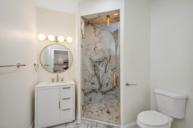 bathroom with toilet, vanity, and a shower with shower door