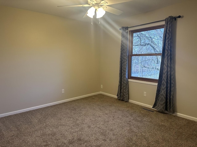 carpeted spare room featuring ceiling fan