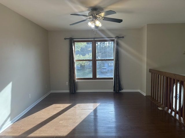 unfurnished room with dark hardwood / wood-style floors and ceiling fan