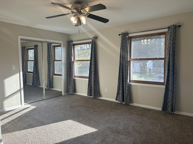 carpeted spare room featuring ceiling fan