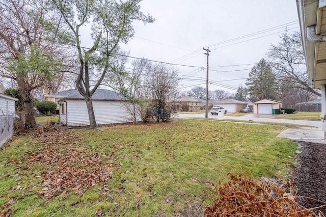 view of yard featuring an outbuilding and a garage