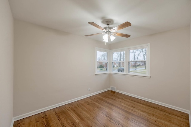 unfurnished room featuring hardwood / wood-style flooring and ceiling fan