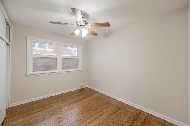 empty room featuring hardwood / wood-style floors and ceiling fan