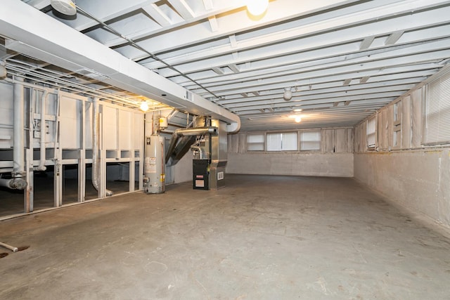 basement featuring gas water heater and heating unit