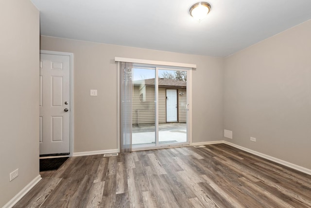 unfurnished room with hardwood / wood-style flooring