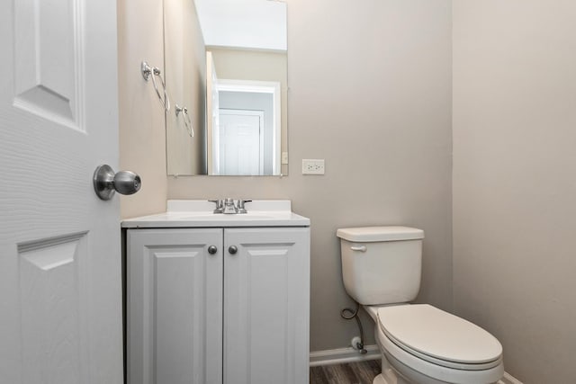 bathroom featuring hardwood / wood-style flooring, vanity, and toilet