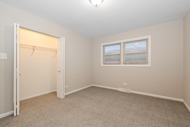 unfurnished bedroom with carpet floors and a closet