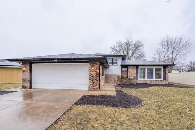 view of front of house featuring a garage and a front lawn