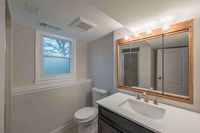 bathroom with tile patterned floors, vanity, toilet, and walk in shower