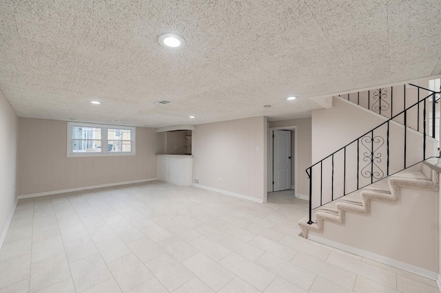 basement featuring a textured ceiling