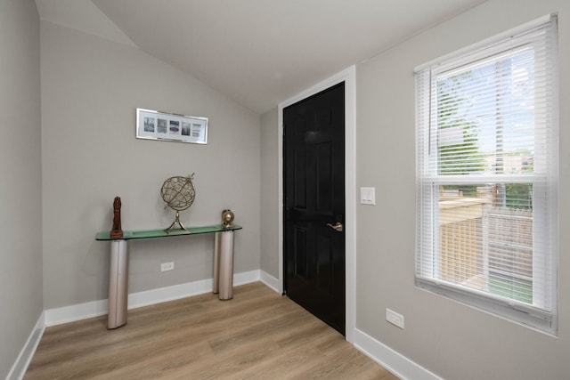 entryway featuring light hardwood / wood-style flooring and lofted ceiling