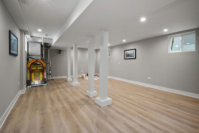 basement with light hardwood / wood-style flooring