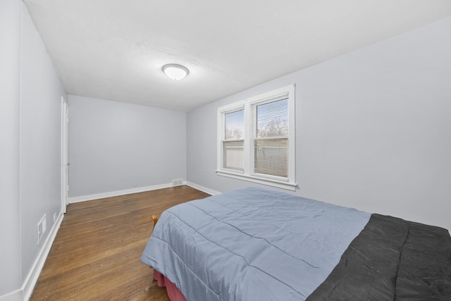 bedroom with hardwood / wood-style flooring