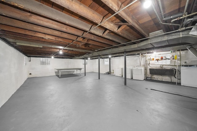 basement with independent washer and dryer and sink