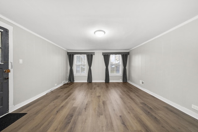 empty room featuring hardwood / wood-style floors and crown molding