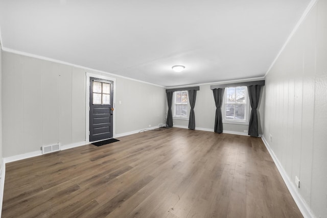 unfurnished room with ornamental molding and dark wood-type flooring