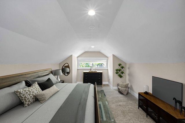 bedroom with light colored carpet and vaulted ceiling