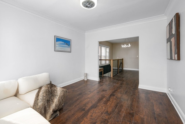 interior space featuring ornamental molding, an inviting chandelier, and dark wood-type flooring