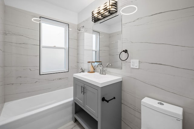 full bathroom with vanity, toilet, shower / washtub combination, and tile walls