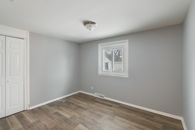 unfurnished room featuring wood-type flooring