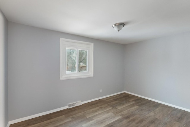 spare room with dark wood-type flooring