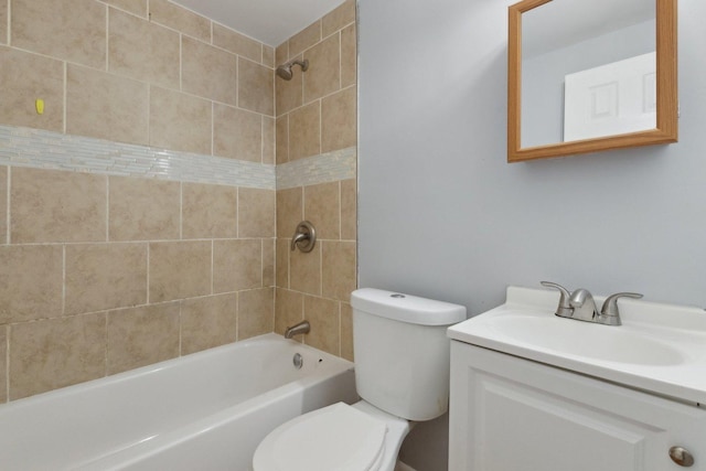 full bathroom with tiled shower / bath, vanity, and toilet