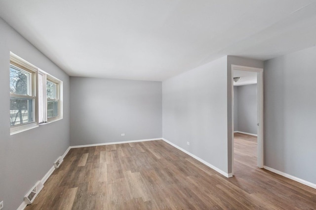 unfurnished room with wood-type flooring