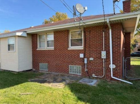 rear view of house featuring a yard