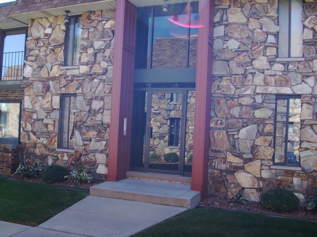 view of exterior entry featuring a balcony