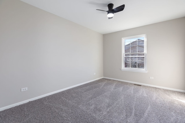 carpeted spare room with ceiling fan