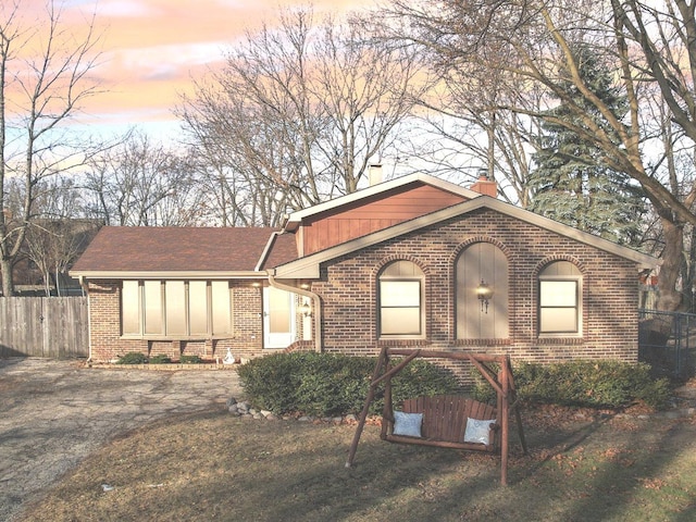 ranch-style home with a lawn