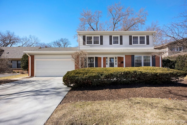 traditional-style home with brick siding, driveway, and a garage