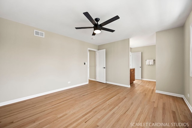 spare room featuring baseboards, visible vents, light wood finished floors, and ceiling fan