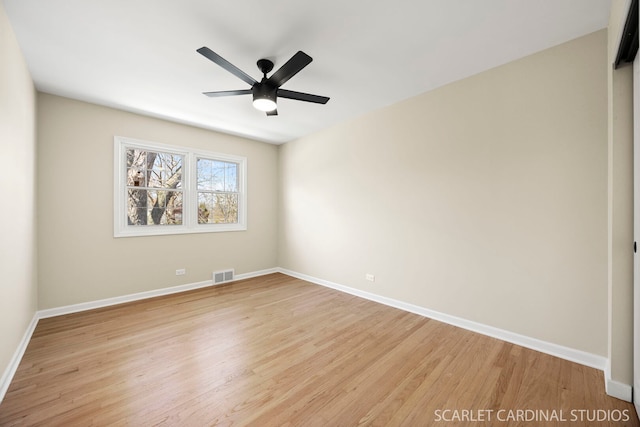 spare room featuring visible vents, light wood-type flooring, and baseboards