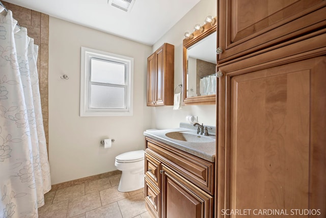 bathroom featuring tile patterned flooring, visible vents, baseboards, toilet, and vanity