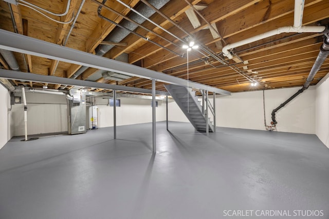 unfinished basement featuring stairway and gas water heater