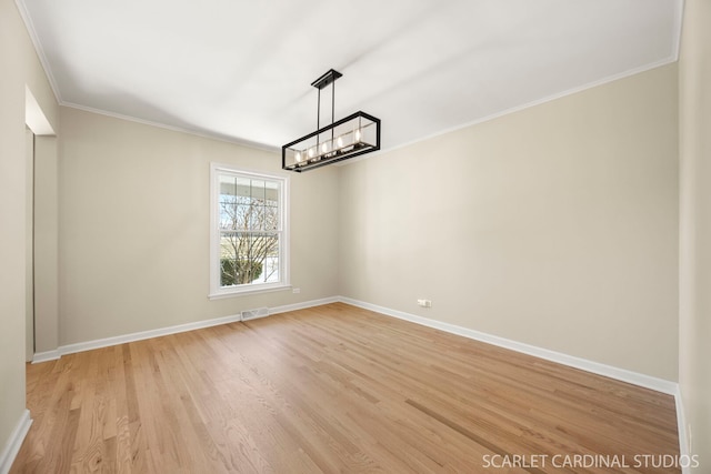 spare room featuring visible vents, crown molding, baseboards, a chandelier, and light wood-type flooring