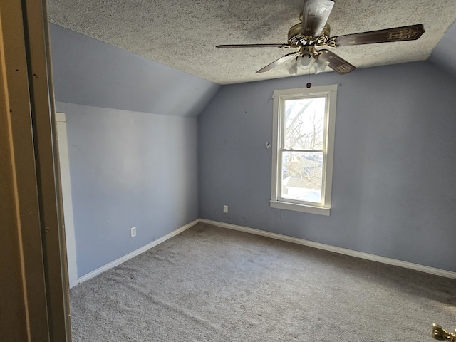 bonus room featuring carpet flooring, lofted ceiling, ceiling fan, and a textured ceiling